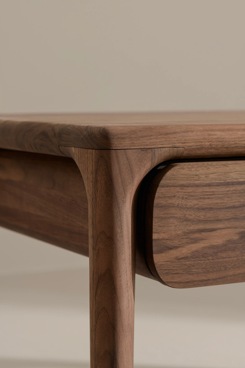It rests on our classic oval tapered legs and features a floating drawer design